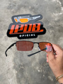 Óculos de Sol Lupa do Vilão Preto Lente Clear Ruby